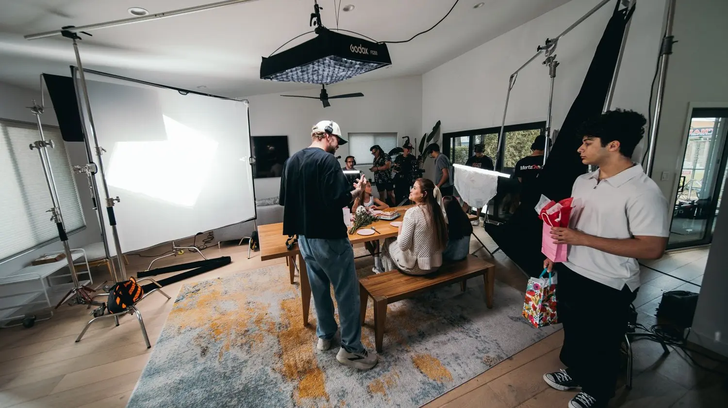 Crew rigging a white-screen interior set