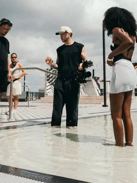 Kyle Loftus directing talent from the pool on a rooftop shoot